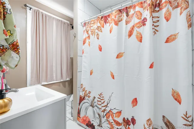 a white cabinet with a white curtain