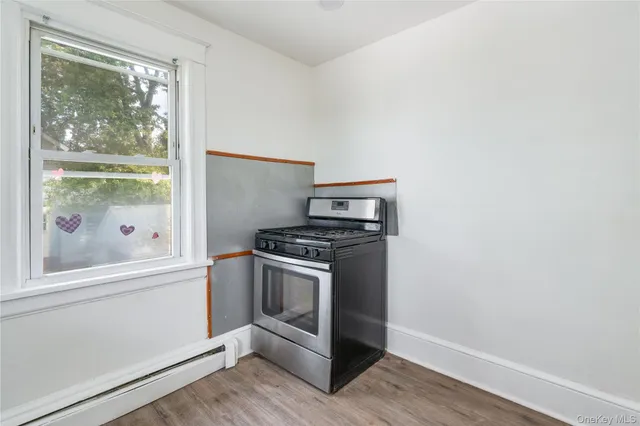 a kitchen with a stove microwave and a window