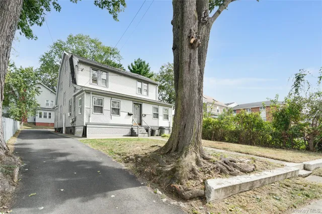 a view of a house with a tree in the background
