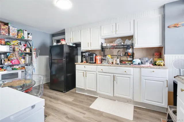 a kitchen with a refrigerator and cabinets