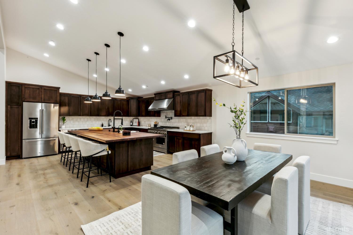 2051 Nez Perce Drive South Lake Tahoe, CA 96150 - Photo 11 of 40 a kitchen with a kitchen island a sink dining table and chairs