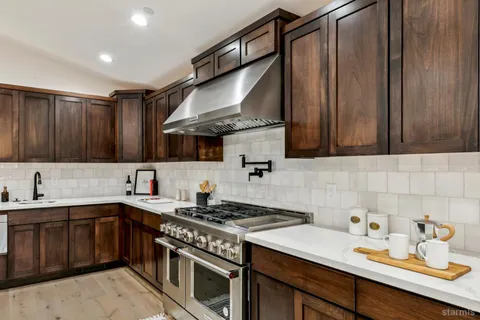 a kitchen with a sink a stove and cabinets