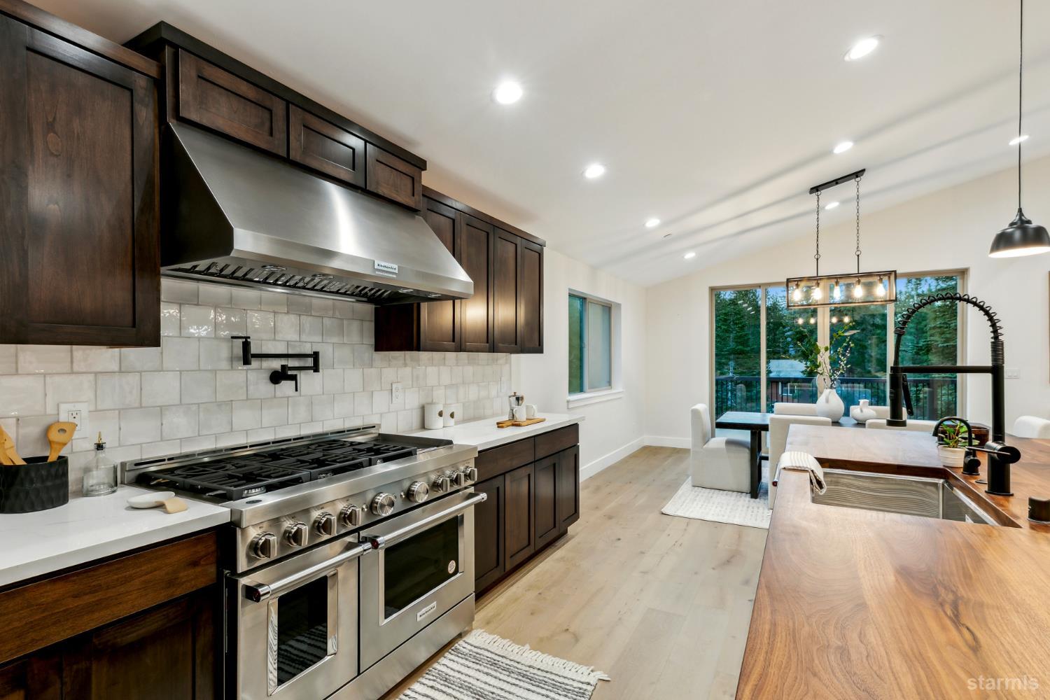 2051 Nez Perce Drive South Lake Tahoe, CA 96150 - Photo 19 of 40 a kitchen with stainless steel appliances a stove sink and wooden floor
