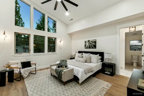 a bed room with a bed and a large window