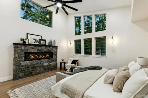 a living room with furniture a fireplace and windows