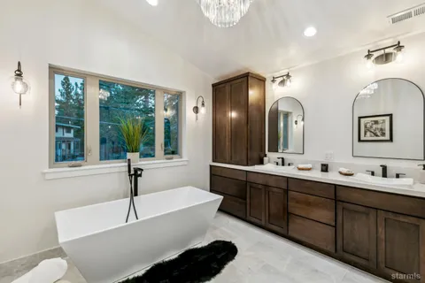 a spacious bathroom with a double vanity sink and a large mirror