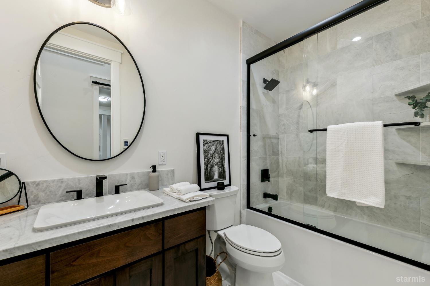 2051 Nez Perce Drive South Lake Tahoe, CA 96150 - Photo 28 of 40 a bathroom with a sink a toilet and a mirror