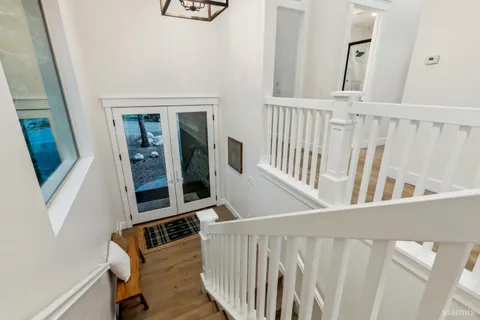 a view of an entryway with wooden floor
