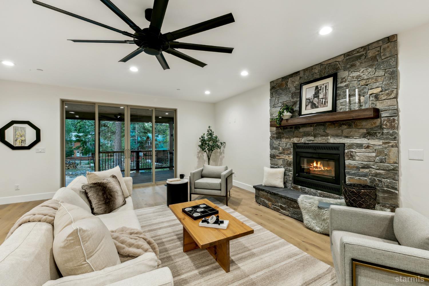 2051 Nez Perce Drive South Lake Tahoe, CA 96150 - Photo 31 of 40 a living room with furniture a rug and a fireplace