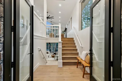a view of entryway and hall with wooden floor
