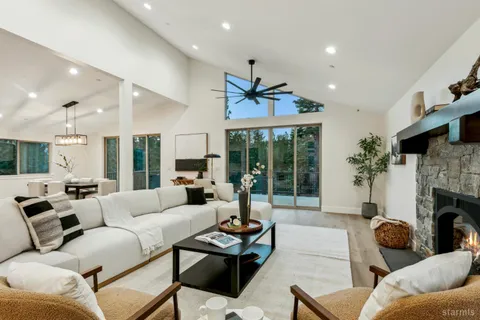 a living room with furniture fireplace and a large window