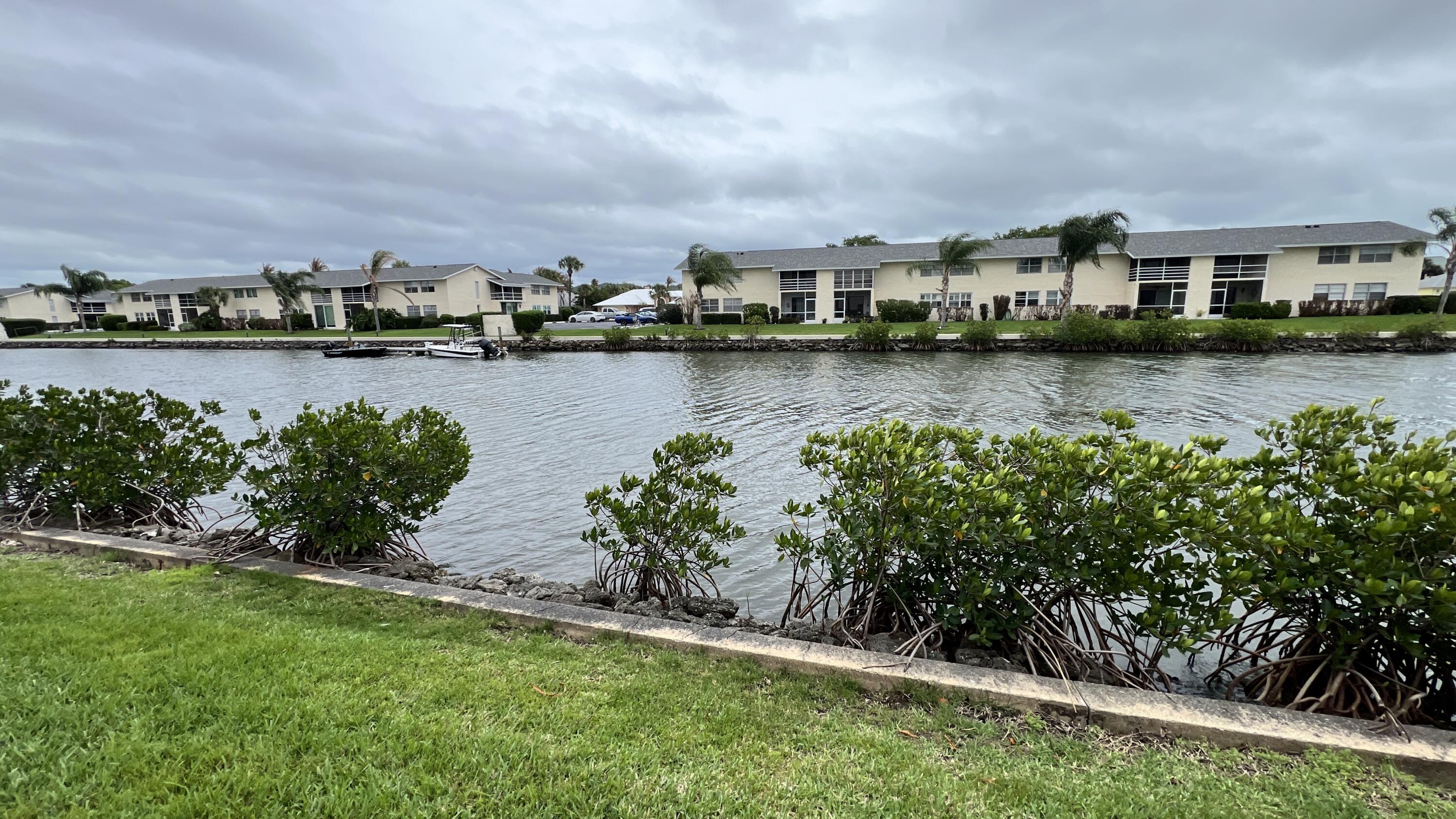 1860 Robalo Drive, Unit 104 Vero Beach, FL 32960 - Photo 11 of 11 a view of lake with house