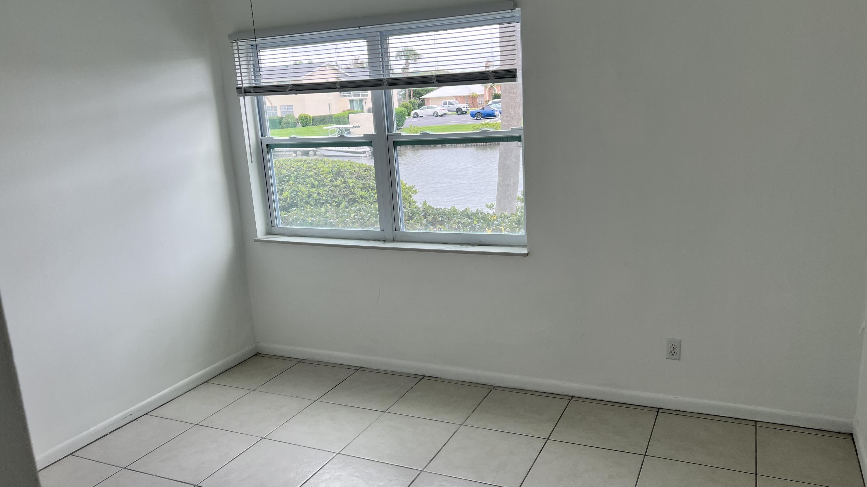 1860 Robalo Drive, Unit 104 Vero Beach, FL 32960 - Photo 2 of 11 an empty room with windows