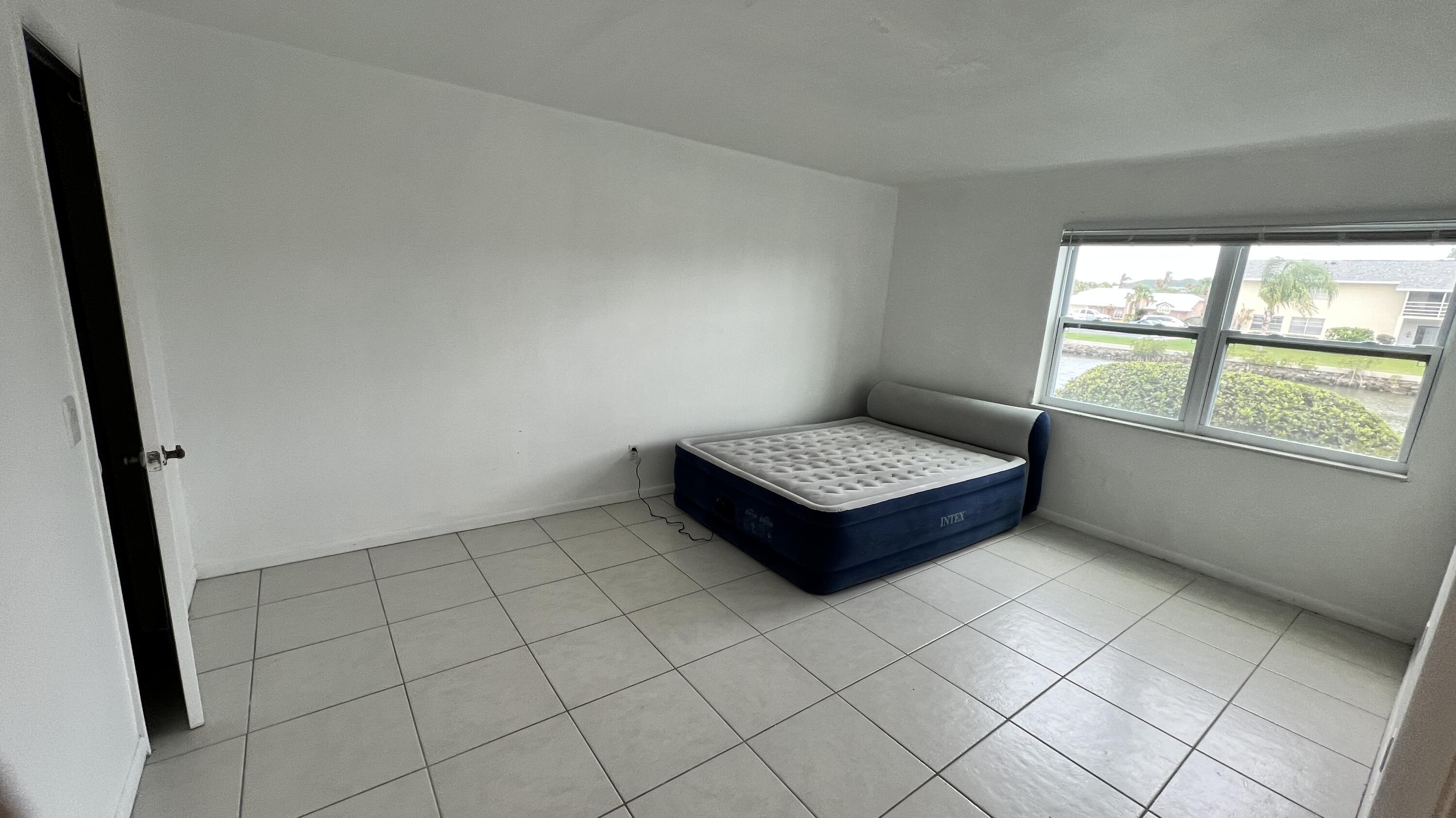 1860 Robalo Drive, Unit 104 Vero Beach, FL 32960 - Photo 3 of 11 a view of an empty room and window