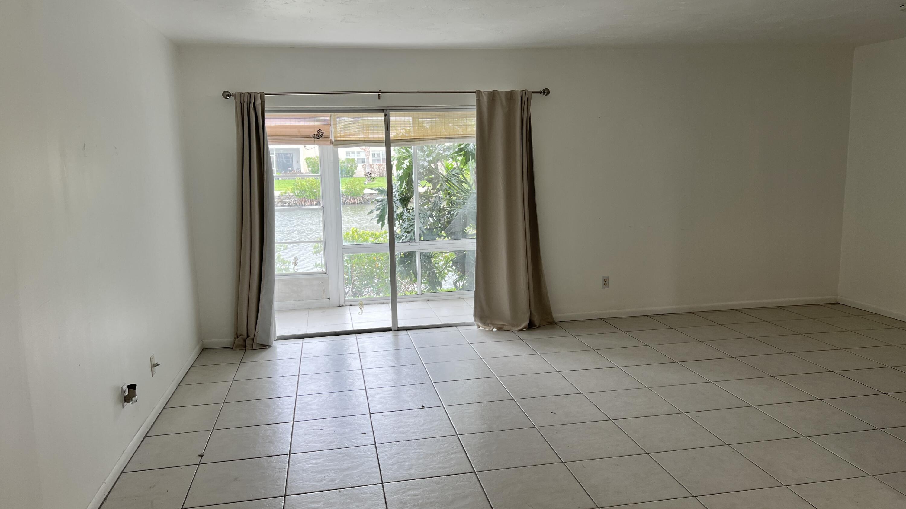 1860 Robalo Drive, Unit 104 Vero Beach, FL 32960 - Photo 4 of 11 a view of an empty room and window