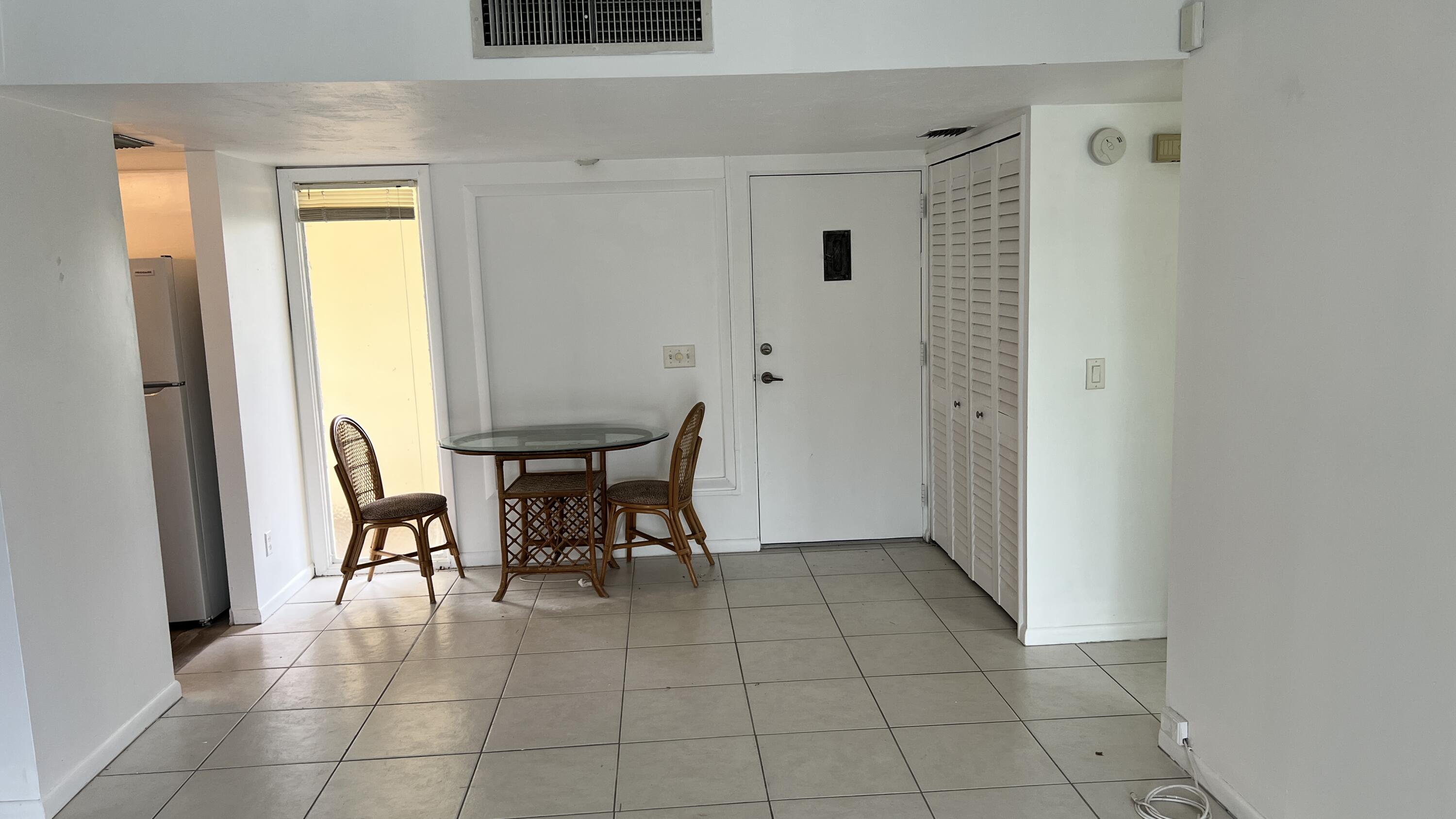 1860 Robalo Drive, Unit 104 Vero Beach, FL 32960 - Photo 5 of 11 a view of kitchen with furniture and window