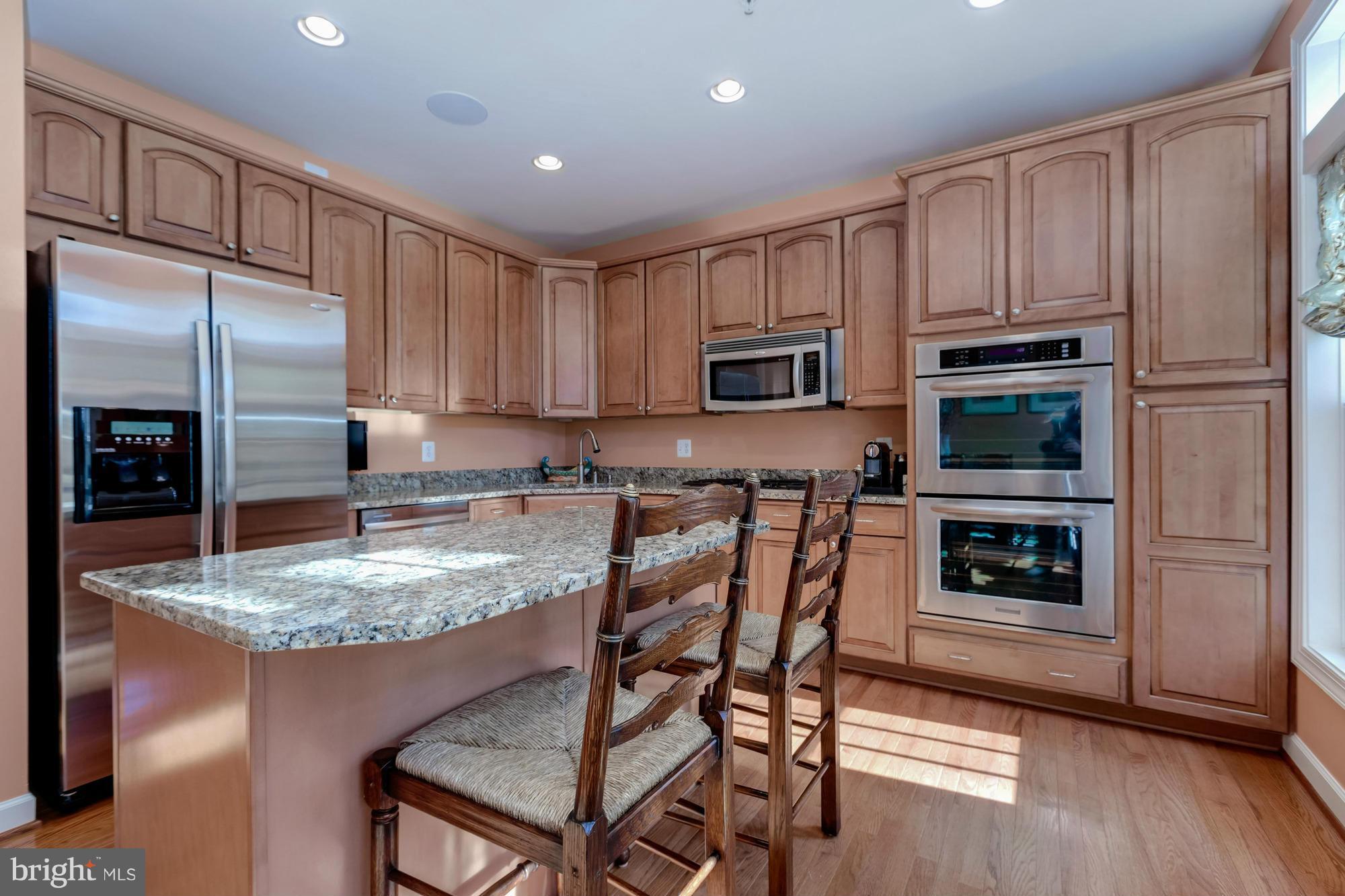 842 West Glebe Road Alexandria, VA 22305 - Photo 8 of 30 a kitchen with kitchen island granite countertop stainless steel appliances a stove refrigerator and microwave