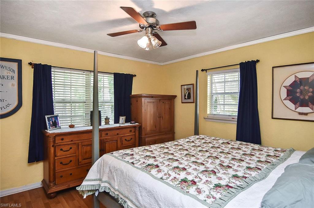 1431 Collins Road Fort Myers, FL 33919 - Photo 11 of 30 a bedroom with a bed and wooden floor