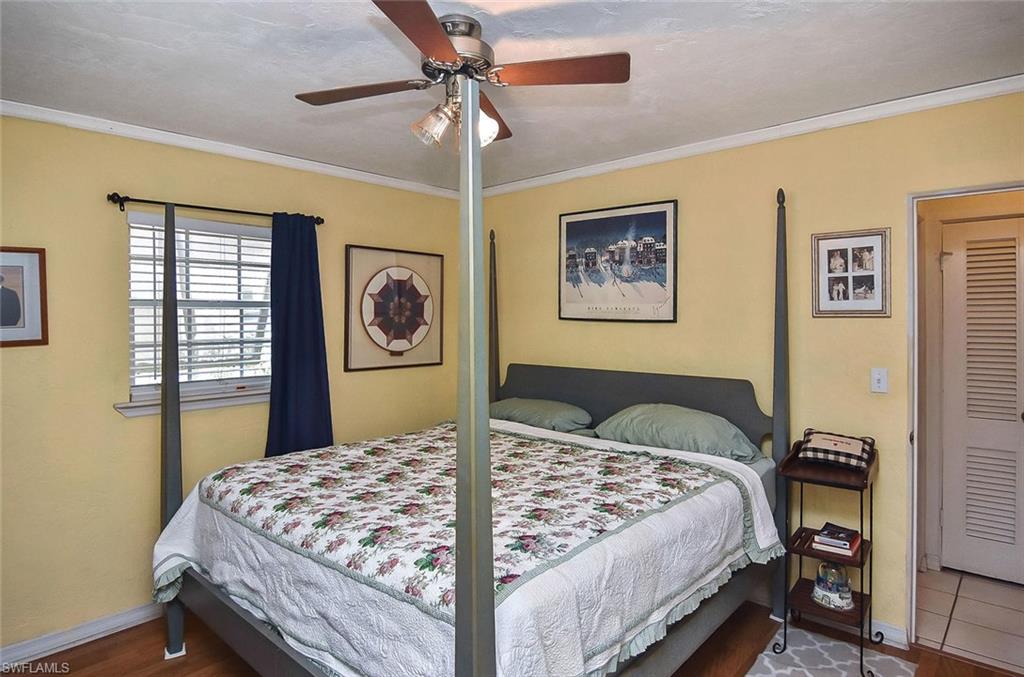 1431 Collins Road Fort Myers, FL 33919 - Photo 12 of 30 a bedroom with a large bed and a chandelier