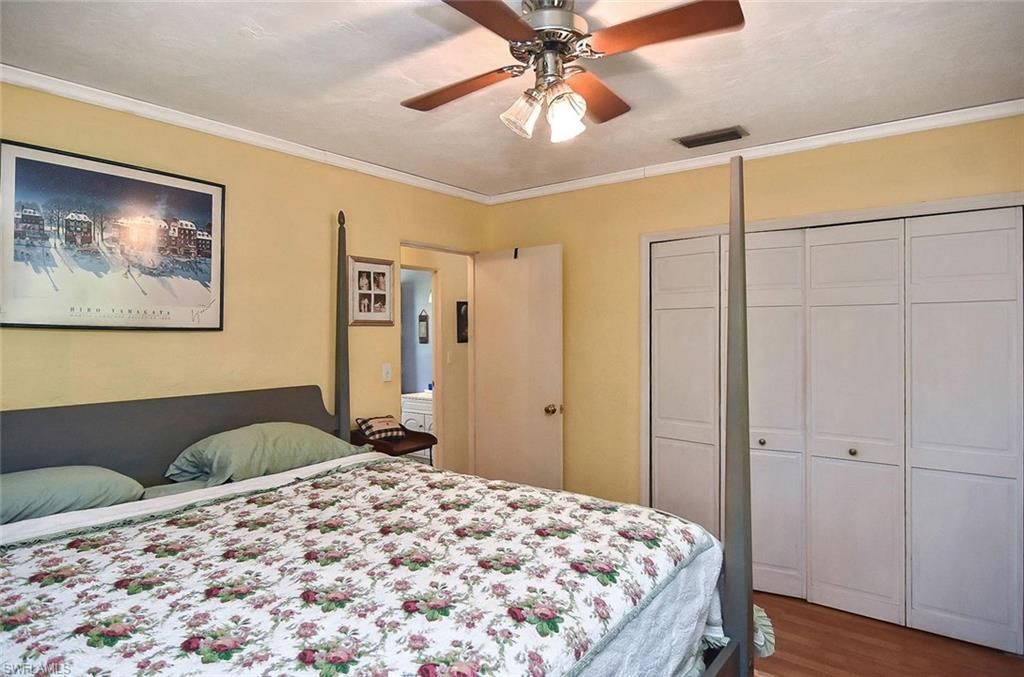 1431 Collins Road Fort Myers, FL 33919 - Photo 13 of 30 a bedroom with a bed and a chandelier