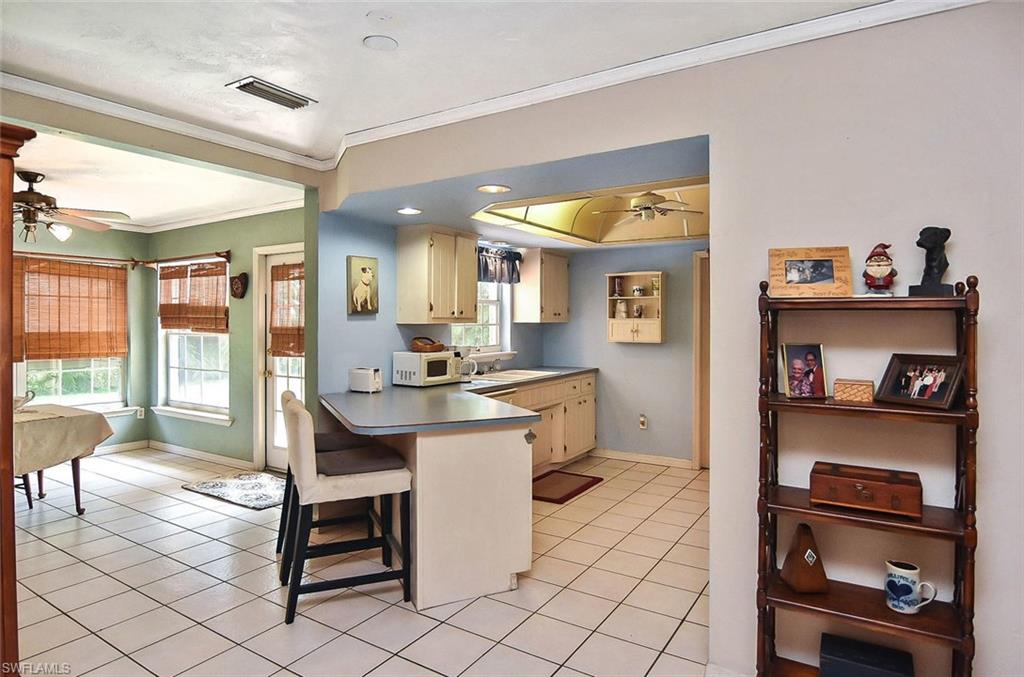 1431 Collins Road Fort Myers, FL 33919 - Photo 14 of 30 a view of kitchen island with furniture and window