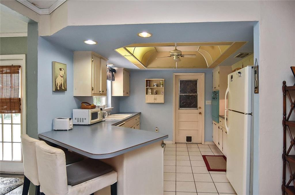 1431 Collins Road Fort Myers, FL 33919 - Photo 15 of 30 a kitchen with stainless steel appliances a sink and cabinets