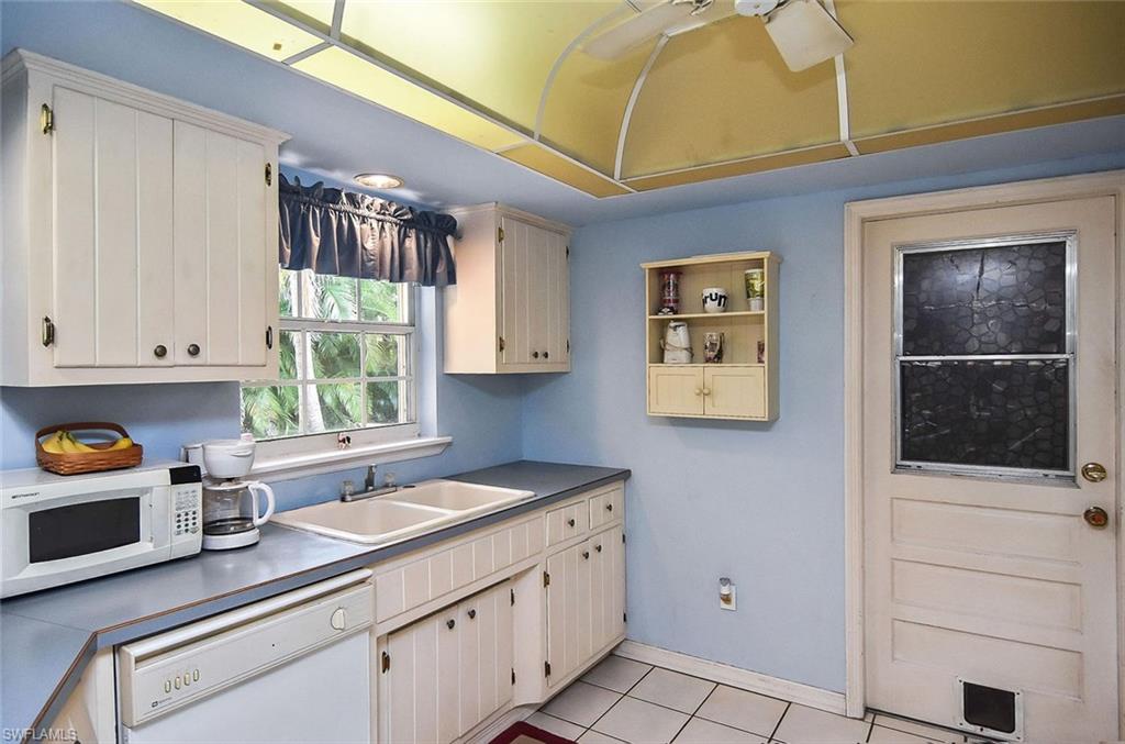 1431 Collins Road Fort Myers, FL 33919 - Photo 17 of 30 a kitchen with a cabinets and window