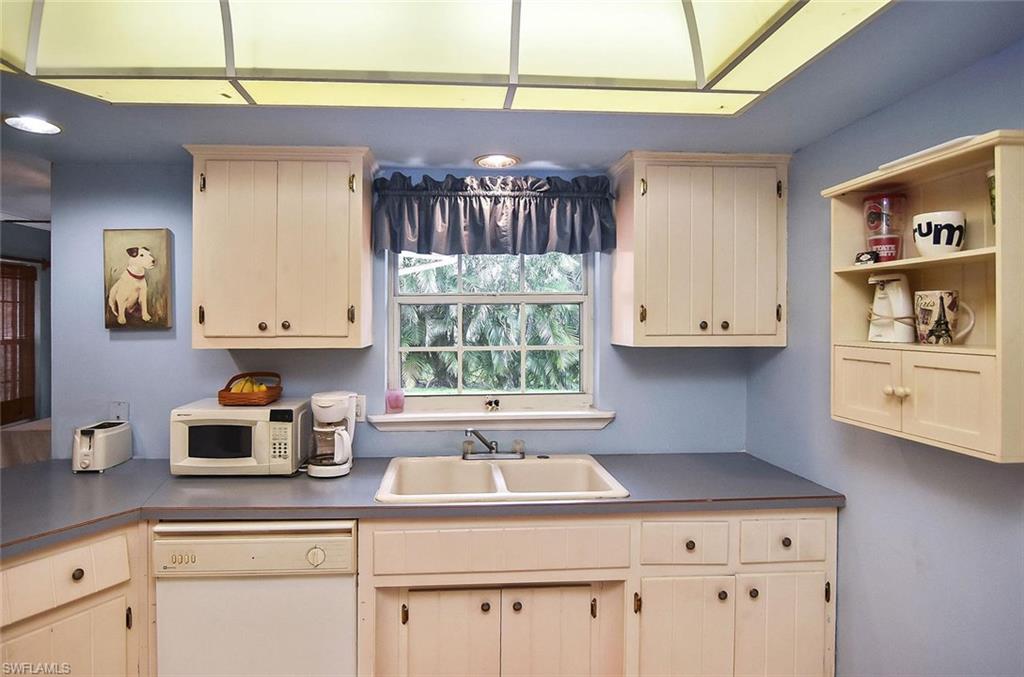 1431 Collins Road Fort Myers, FL 33919 - Photo 19 of 30 a kitchen with a sink cabinets and a window