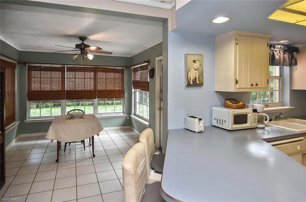 1431 Collins Road Fort Myers, FL 33919 - Photo 21 of 30 a living room with furniture and a large window