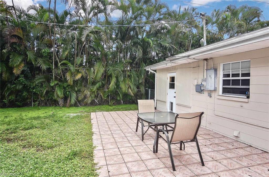 1431 Collins Road Fort Myers, FL 33919 - Photo 27 of 30 a view of backyard with a table and chairs
