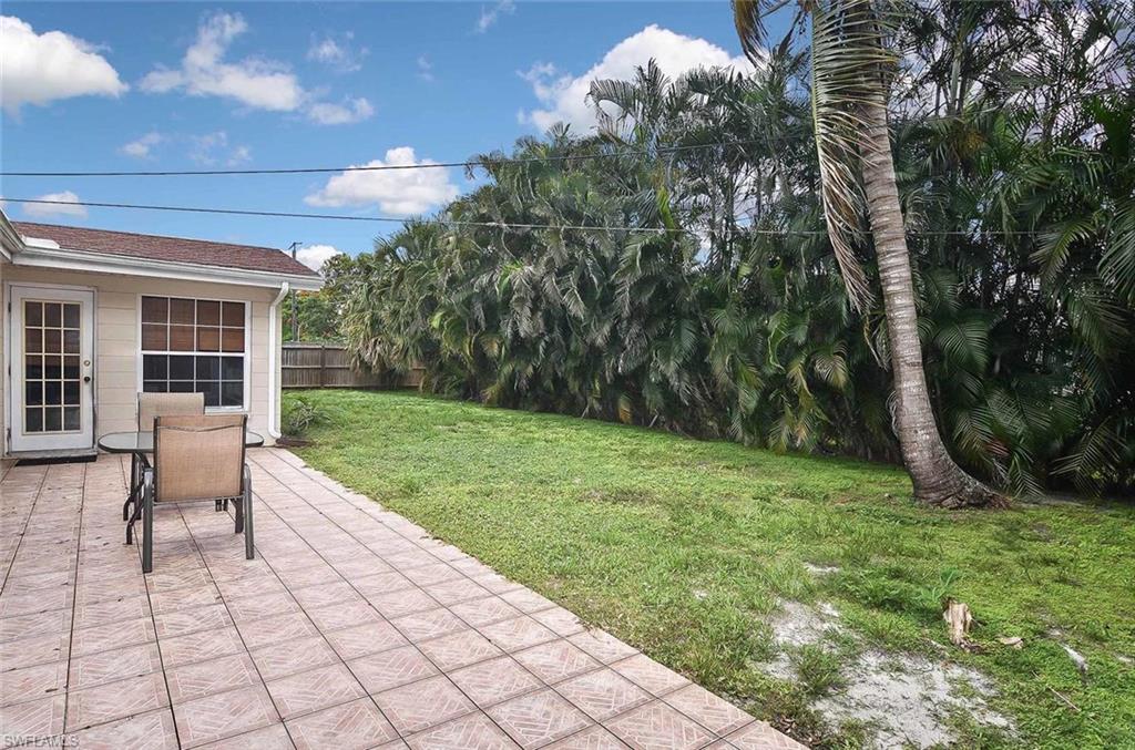 1431 Collins Road Fort Myers, FL 33919 - Photo 28 of 30 a view of a backyard with table and chairs and potted plants