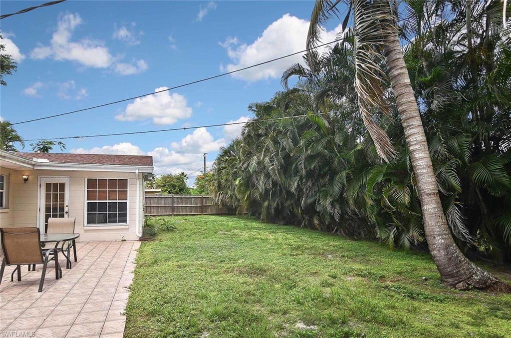 1431 Collins Road Fort Myers, FL 33919 - Photo 29 of 30 a view of a backyard with table and chairs and potted plants