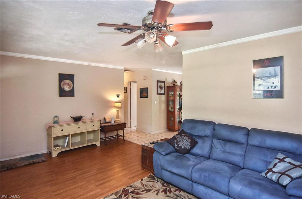 1431 Collins Road Fort Myers, FL 33919 - Photo 7 of 30 a living room with furniture and a chandelier
