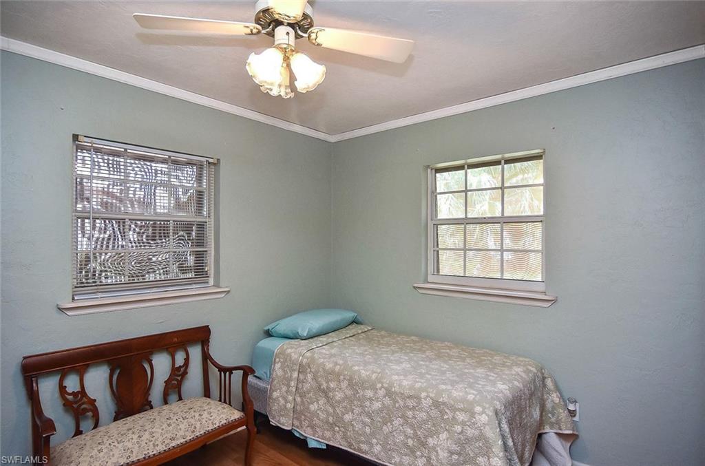 1431 Collins Road Fort Myers, FL 33919 - Photo 9 of 30 a bedroom with a bed next to a window