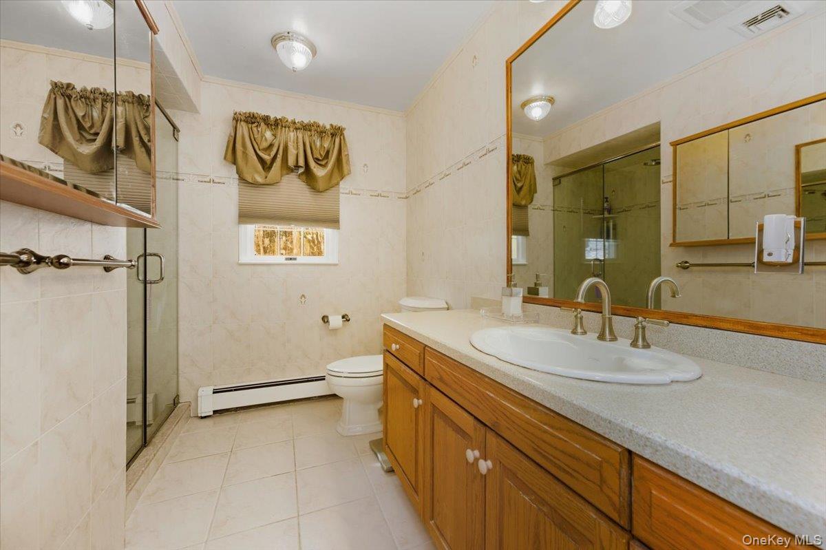 15 Lake Gilead Road Carmel, NY 10512 - Photo 16 of 27 a bathroom with a sink a mirror and a shower