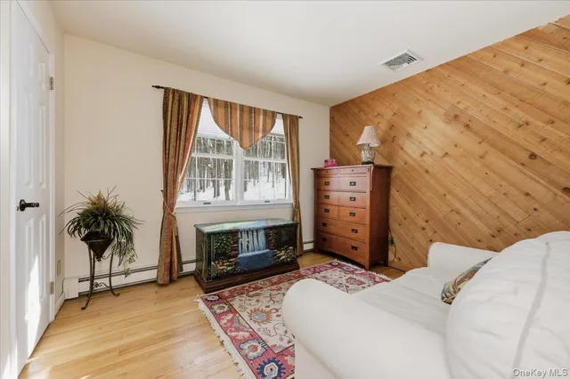 a bedroom with a bed and a television