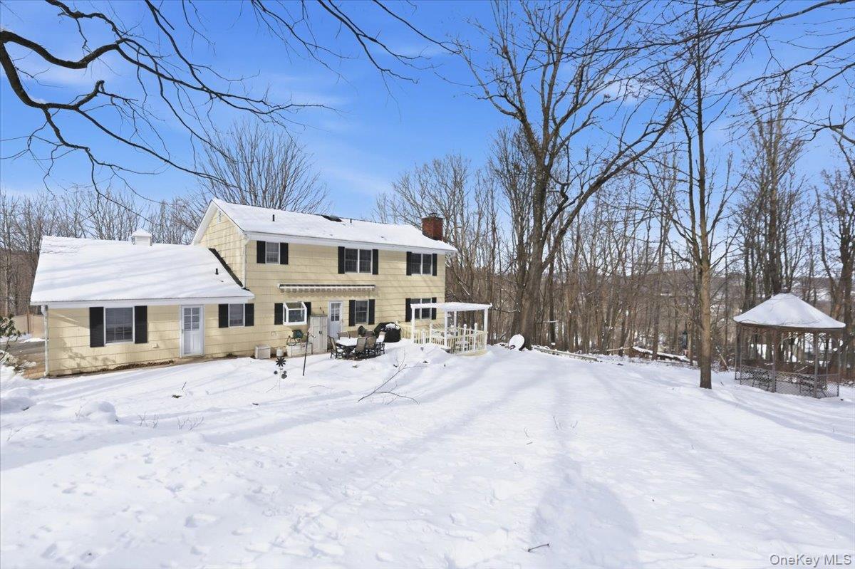 15 Lake Gilead Road Carmel, NY 10512 - Photo 23 of 27 a front view of a house with large trees and wooden fence
