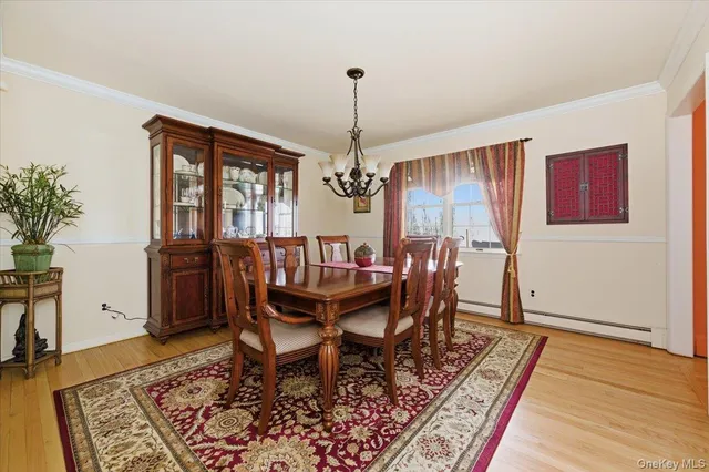 a dining room with furniture window and wooden floor