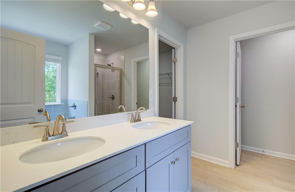 117 Alpine Road Fairburn, GA 30213 - Photo 23 of 29 a bathroom with a sink double vanity and a mirror