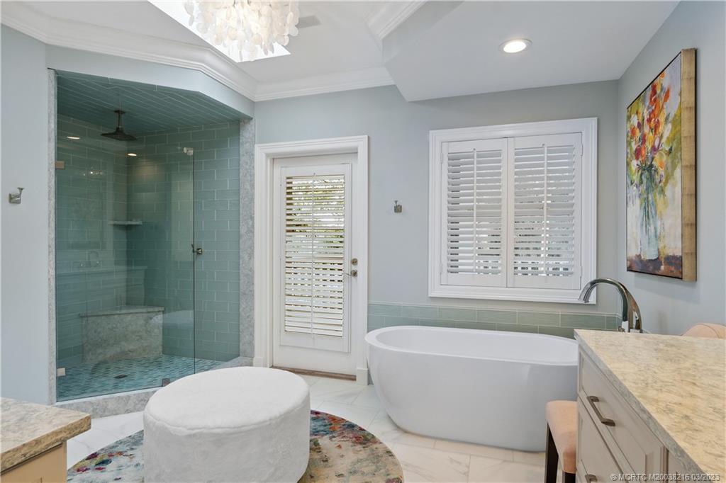 9 Pineapple Lane Stuart, FL 34996 - Photo 18 of 33 a bathroom with a granite countertop toilet a sink and bathtub