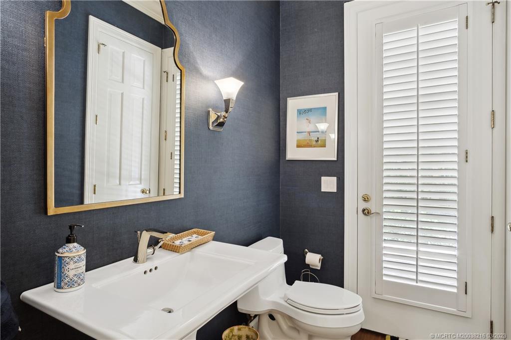 9 Pineapple Lane Stuart, FL 34996 - Photo 26 of 33 a bathroom with a sink a toilet and shower curtain