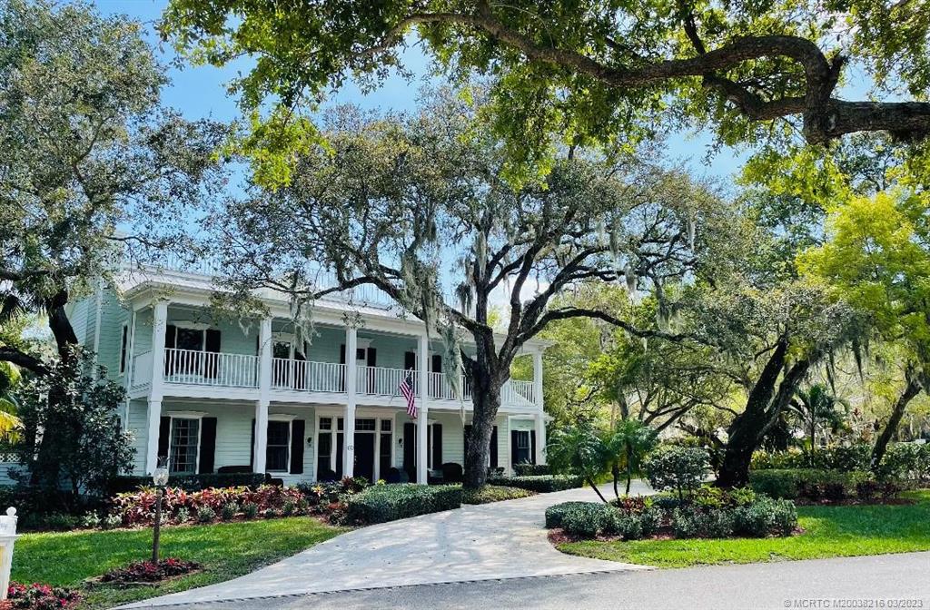 9 Pineapple Lane Stuart, FL 34996 - Photo 32 of 33 a front view of a house with a yard and potted plants