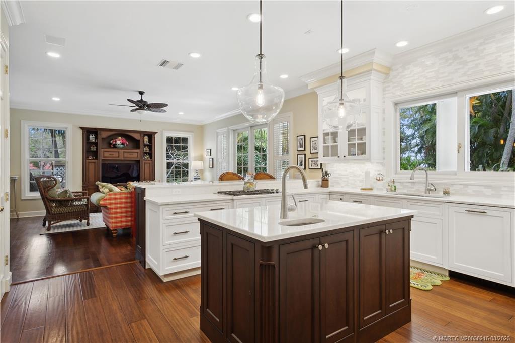 9 Pineapple Lane Stuart, FL 34996 - Photo 8 of 33 a kitchen with stainless steel appliances granite countertop a sink a stove and a wooden floor