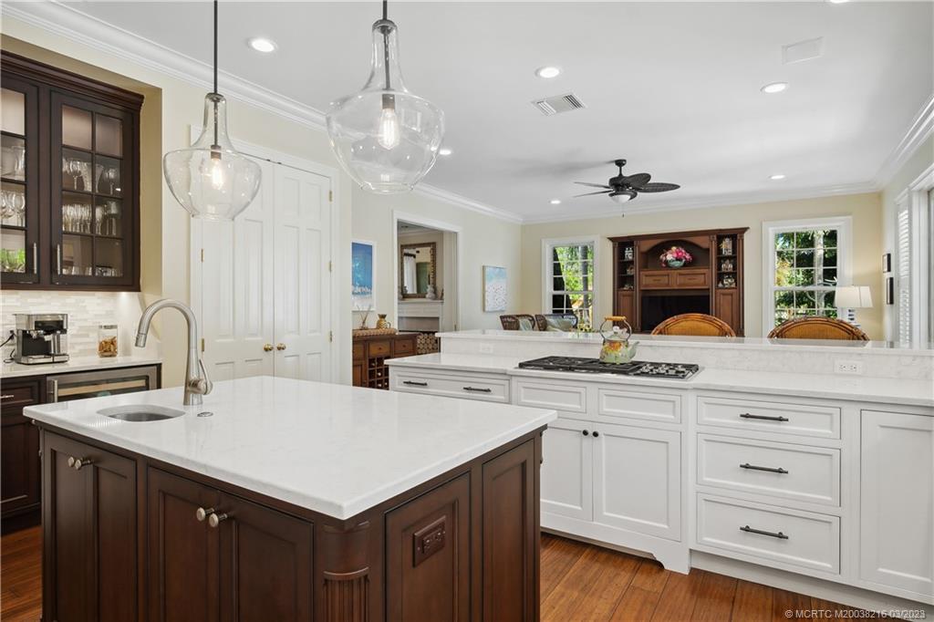 9 Pineapple Lane Stuart, FL 34996 - Photo 9 of 33 a kitchen with a sink dishwasher and a stove with wooden floor