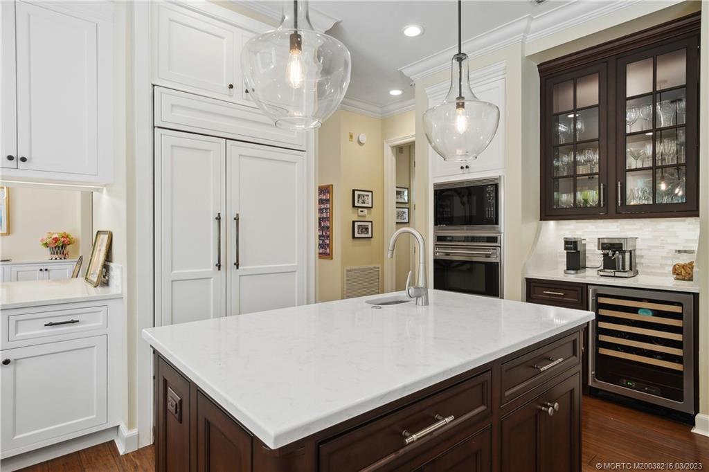 9 Pineapple Lane Stuart, FL 34996 - Photo 10 of 33 a kitchen with a refrigerator a stove cabinets and wooden floor