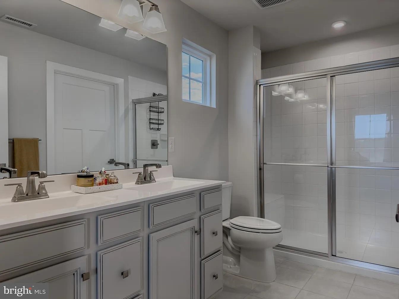 18 Bustleton Millville, NJ 08332 - Photo 8 of 19 a bathroom with a toilet sink and mirror