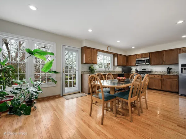 a dining room with furniture and a wooden floor