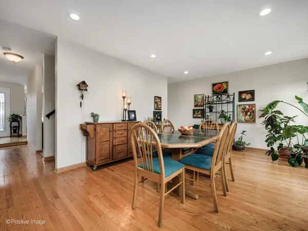 a dining room with furniture and wooden floor