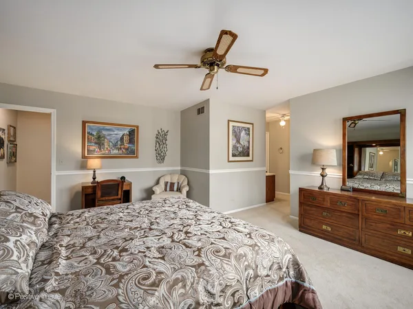 a bedroom with a large bed and a dresser