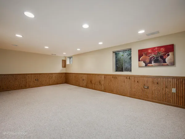 a view of an empty room with painting on the wall